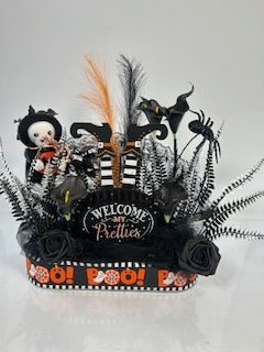 A completed, decorated fairy garden in a three sided pot.