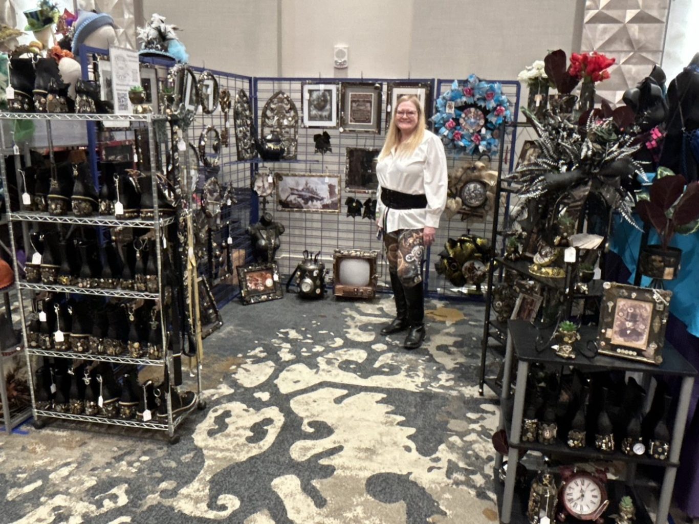 Artist Roxanne inside her booth at a recent steampunk festival with a huge inventory of her creations.